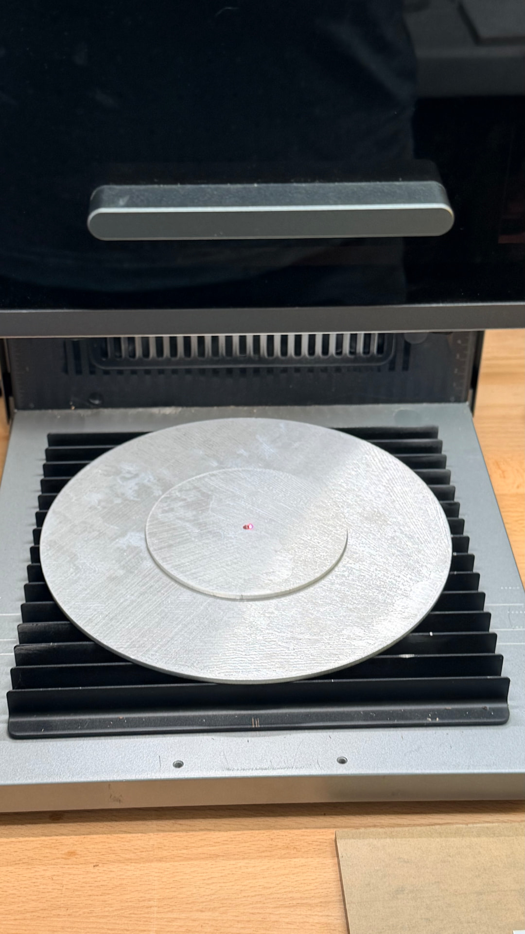 Aluminum disc set up on the laser bed for alignment