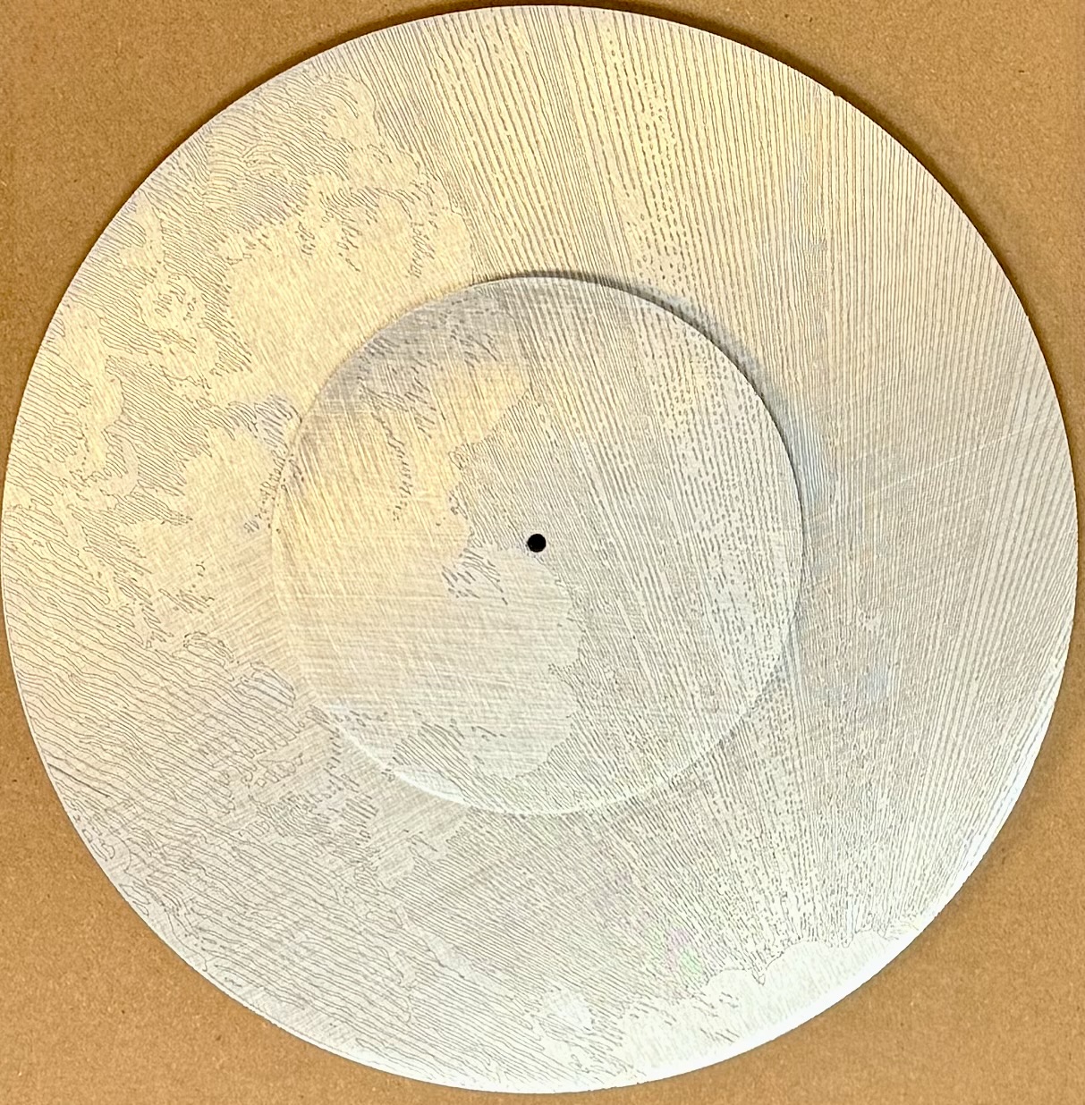 Layered wood disc with fine cloud engraving